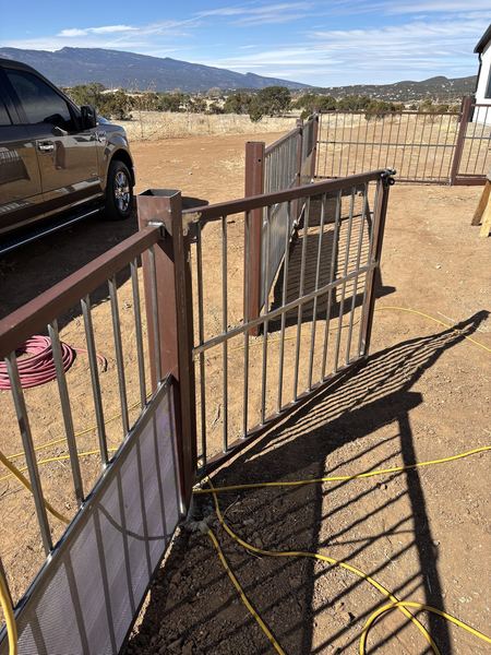 Steel ranch gate and fence panels with mesh lower sections